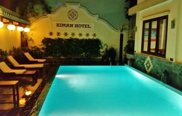 The luxurious swimming pool at Kiman Hoi An Hotel and Spa, located in Hoi An, Vietnam, offering relaxation and comfort.