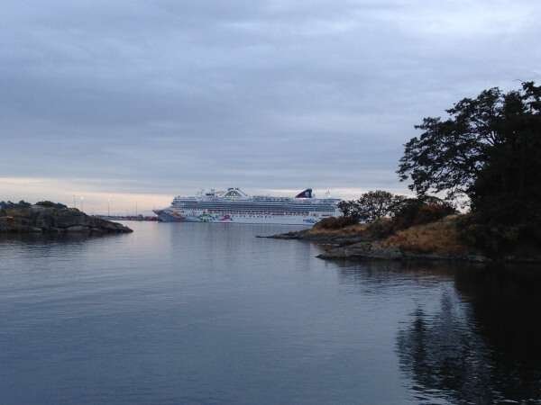 NCL Cruise Ship docked in Victoria, BC, offering luxury cruises through beautiful coastal waters.