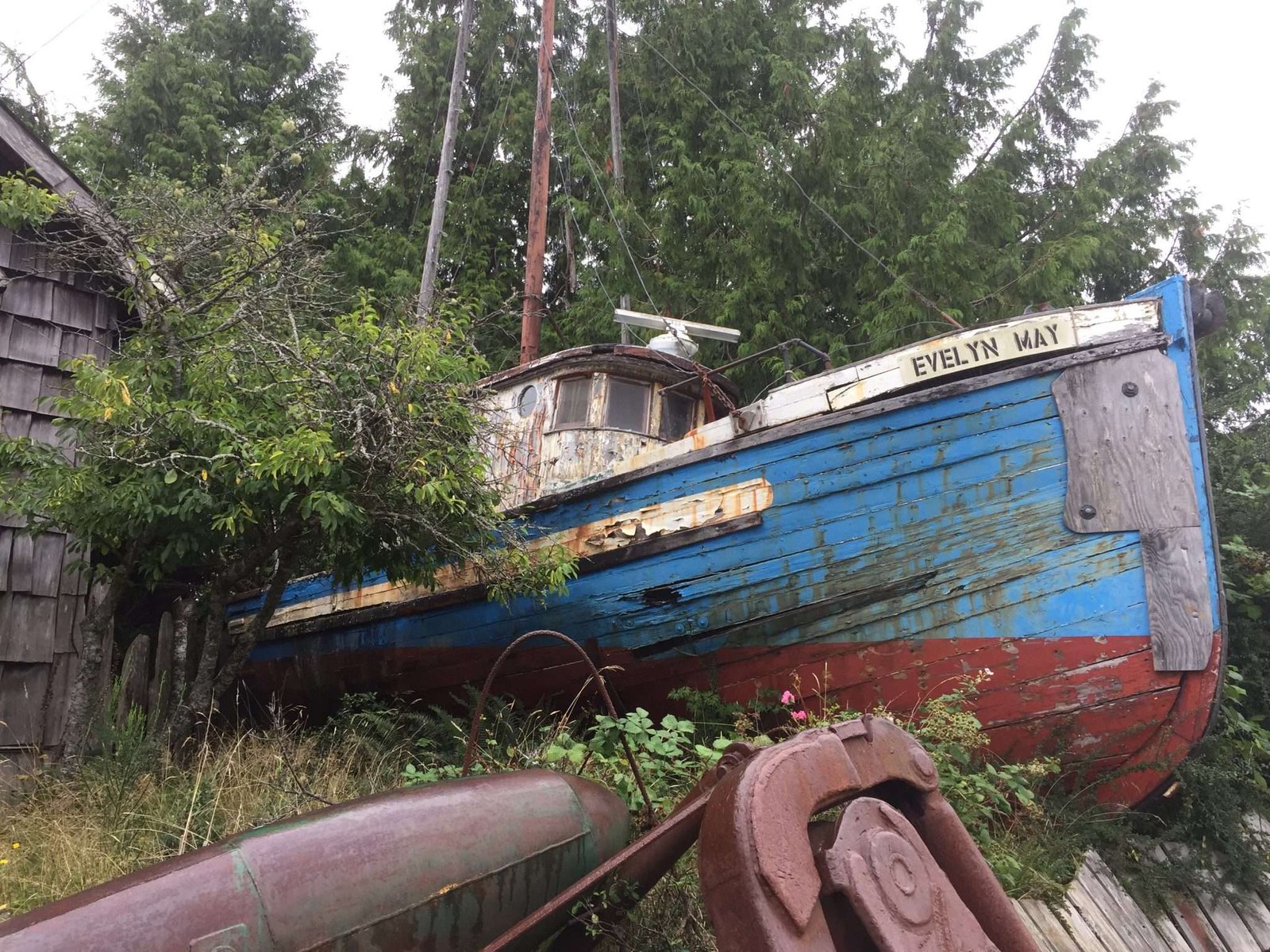 A retired fish boat docked by the coast, now serving as a nostalgic reminder of maritime history.