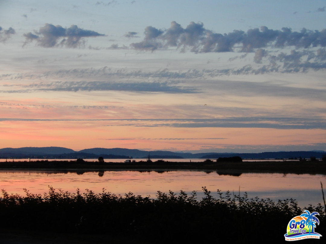 Stunning sunset view in Sidney, British Columbia, overlooking the waterfront and distant mountains.