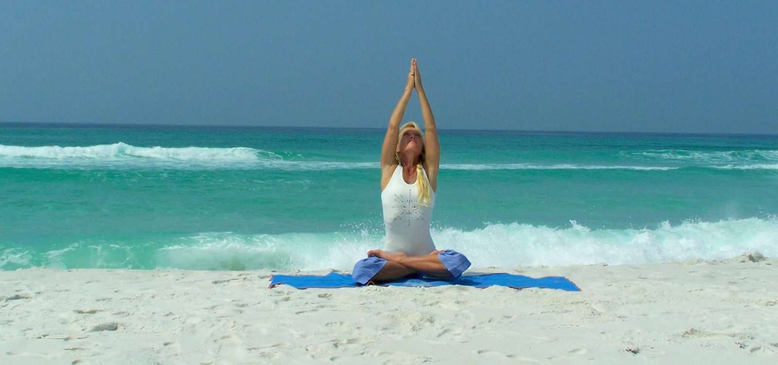 A serene image of yoga practice on a beach, promoting mindfulness and relaxation through yoga.